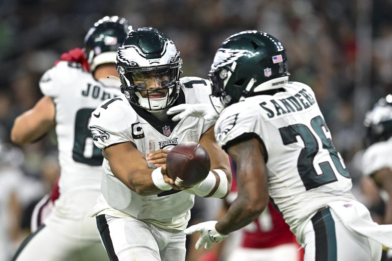 Philadelphia Eagles quarterback Jalen Hurts hands the ball off to running back Miles Sanders during the fourth quarter at NRG Stadium.