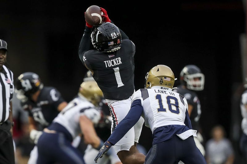 Cincinnati Bearcats wide receiver Tre Tucker (1) catches a pass against Navy Midshipmen safety Rayuan Lane III (18) in the first half at Nippert Stadium.