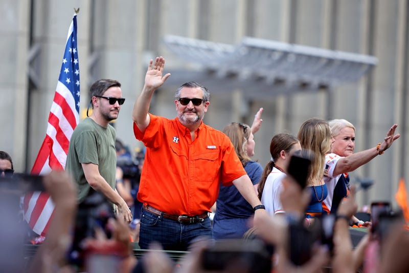 Houston, Texas, USA; State senator Ted Cruz (orange) waves to the crowd during the Houston Astros Championship Parade in Houston, TX. M