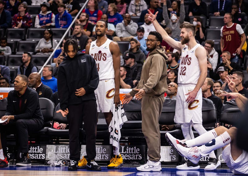 Cleveland Cavaliers guard Darius Garland (left), forward Evan Mobley (4), guard Donovan Mitchell (center right) and forward Dean Wade (32) cheer on their team during a game this season.