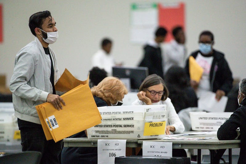 A new shift of election workers wait to begin the counting of absentee ballots at the Huntington Place in Detroit on Tuesday, Nov. 8, 2022.
