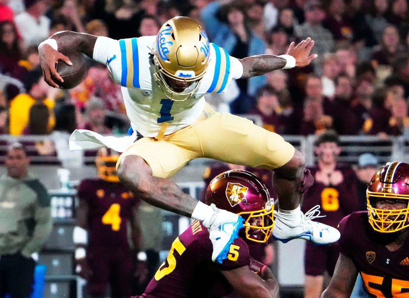Dorian Thompson-Robinson leaping an ASU defender