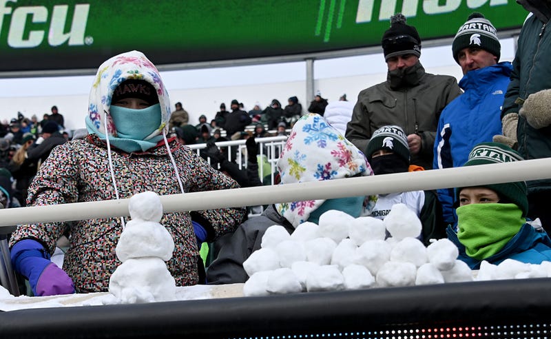 Nov 19, 2022; East Lansing, Michigan, USA; Young Michigan Sate Spartan fans stockpile a large quantity of snow balls and a snow man in the game against the Indiana Hoosiers at Spartan Stadium