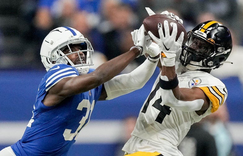 Pittsburgh Steelers wide receiver George Pickens (14) makes a catch while being guarded by Indianapolis Colts cornerback Isaiah Rodgers Sr. (34) on Monday, Nov. 28, 2022, during a game against the Pit...