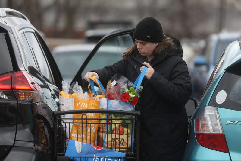 person using reusable bags