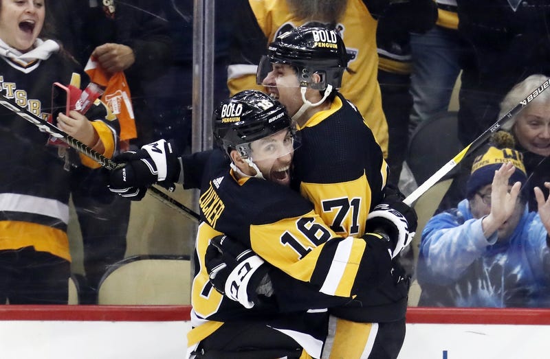 Evgeni Malkin hugs Jason Zucker