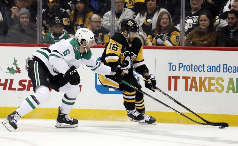 Pittsburgh Penguins left wing Jason Zucker (16) skates with the puck against Dallas Stars defenseman Colin Miller (6) 