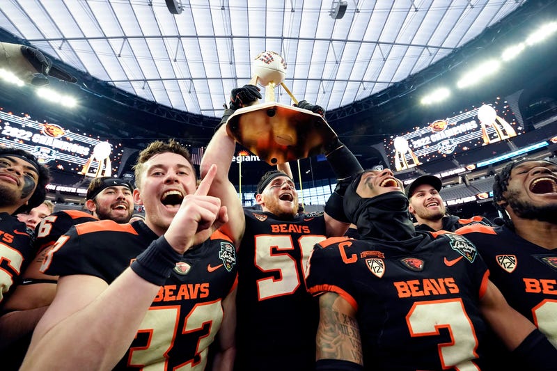 The Oregon State Beavers celebrate with the Las Vegas Bowl trophy after defeating the Florida Gators 30-3 at Allegiant Stadium.