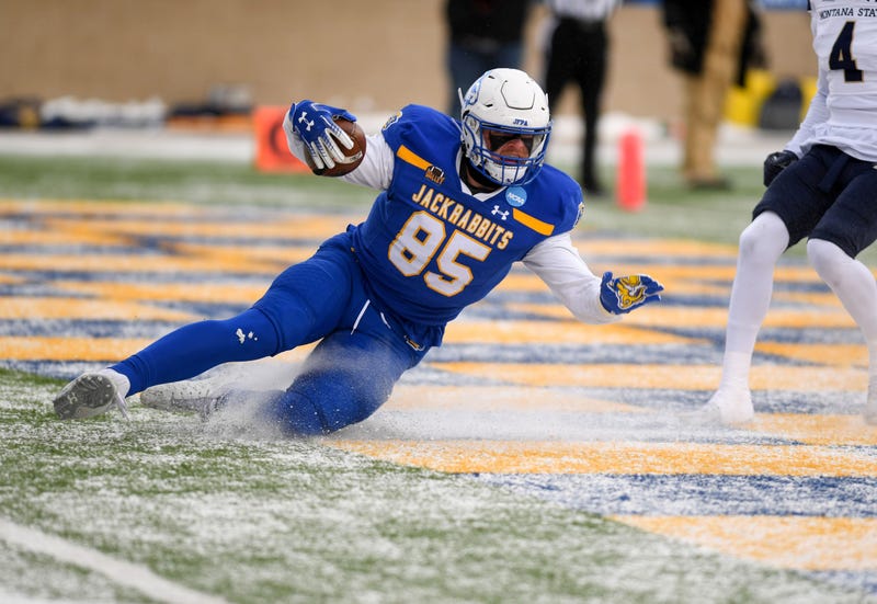 South Dakota State s Tucker Kraft uses the existing layer of snow to slide into the end zone for the first touchdown of the FCS semifinal game against Montana State on Saturday, December 17, 2022, at Dana J. Dykhouse Stadium in Brookings, SD