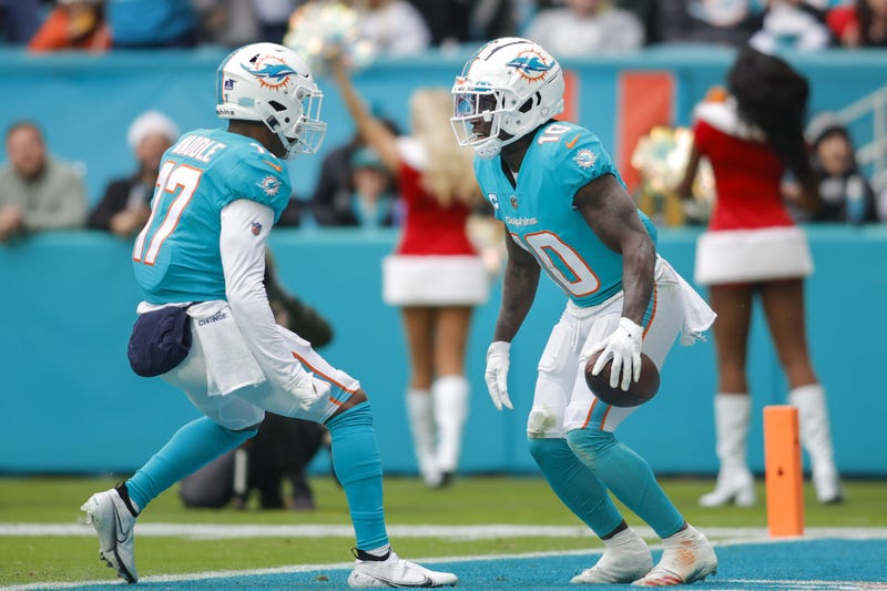 Miami Dolphins wide receiver Tyreek Hill (10) celebrates with wide receiver Jaylen Waddle (17) after catching the football during the second quarter against the Green Bay Packers at Hard Rock Stadium.