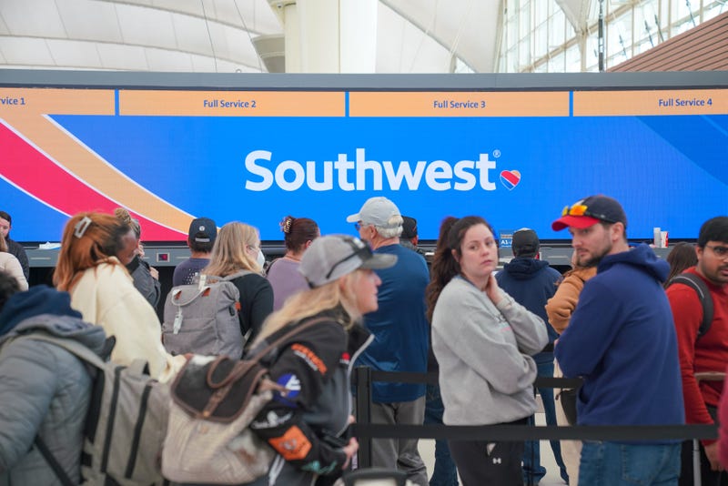 People wait in line for customer assistance from Southwest at Denver International Airport on Dec. 27, 2022.
