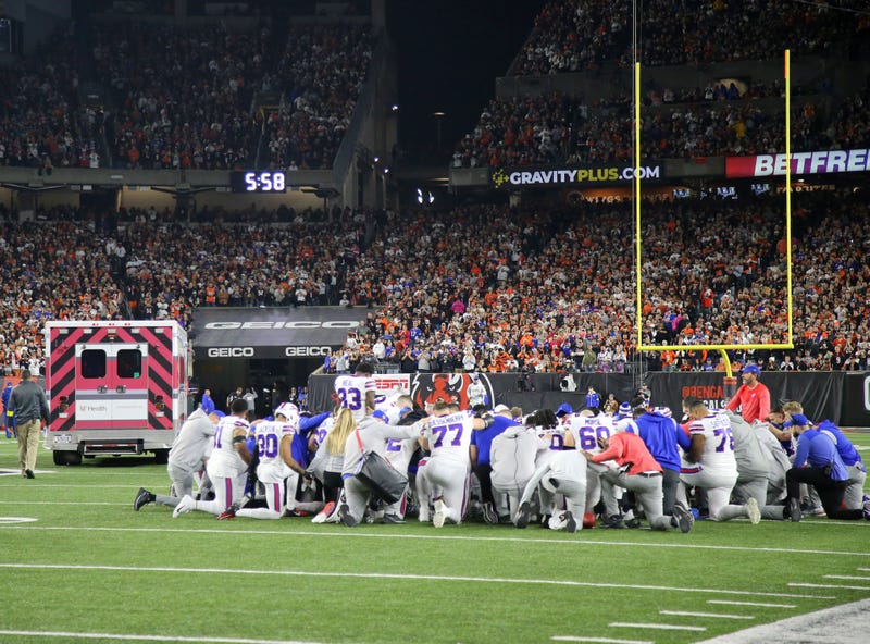 Buffalo Bills players kneel to pray as the ambulance carrying teammate Buffalo Bills safety Damar Hamlin