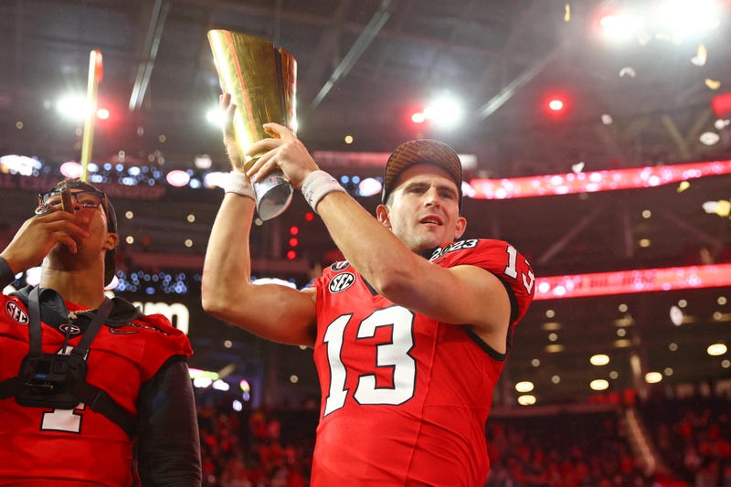 Georgia Bulldogs quarterback Stetson Bennett (13) holds the trophy after winning the CFP national championship game against the TCU Horned Frogsat SoFi Stadium.