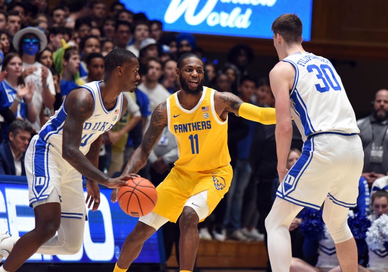 Jamarius Burton with 2 Duke players