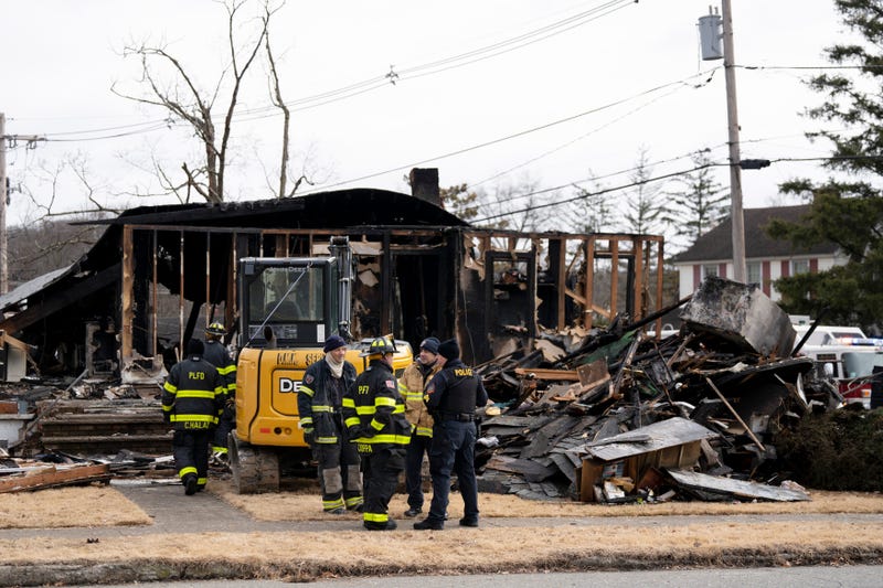 Firefighters sort through the rubble after an explosion during a house fire in Pompton Lakes.