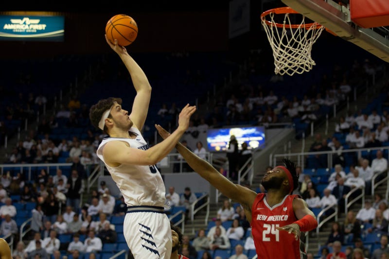 Nevada center Will Baker shoots over New Mexico forward Morris Udeze in the first half of an NCAA college basketball game in Reno, Nev., Monday, Jan. 23, 2023.