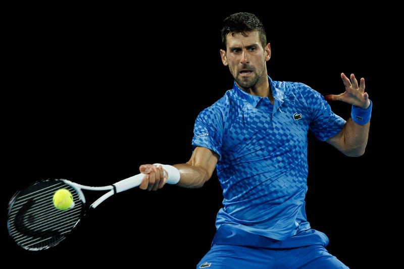 Jan 29, 2023; Melbourne, Victoria, Australia; Novak Djokovic of Serbia hits a shot against Stefanos Tsitsipas of Greece in the men's final on day fourteen of the 2023 Australian Open tennis tournament at Melbourne Park. Mandatory Credit: Mike Frey-USA TODAY Sports