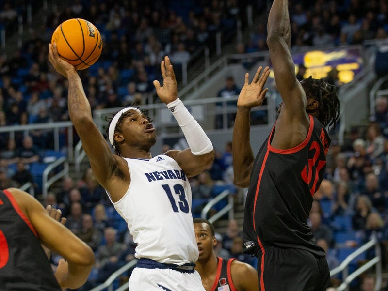 Nevada guard Kenan Blackshear (13) shoots over San Diego State forward Nathan Mensah (31) during the first half of a basketball game played at Lawlor Events Center in Reno on Tuesday, Jan. 31