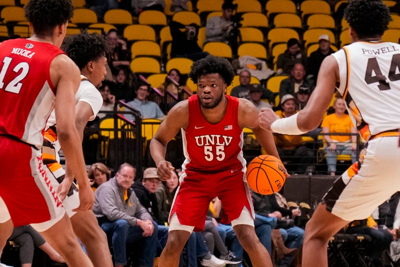 UNLV Runnin' Rebels guard EJ Harkless (55) looks to pass against the Wyoming Cowboys during the second half at Arena-Auditorium.