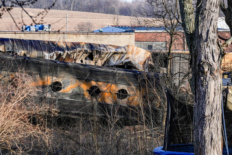 A derailed train car is seen from the backyard of home in East Palestine, Ohio. About 50 train cars,