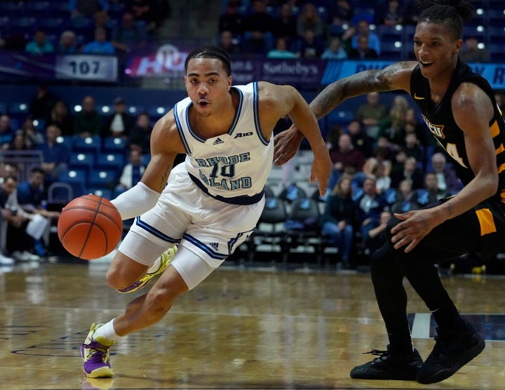 URI guard Ishmael Leggett slips past Nick Kern Jr. of VCU during first half action