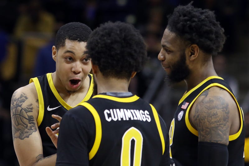 Greg Elliott Nelly Cummings Jamarius Burton talking on the court