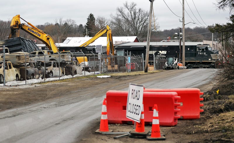 A Norfolk Southern train speeds through East Palestine as crews work to clean up wreckage from the Feb. 3 train derailment
