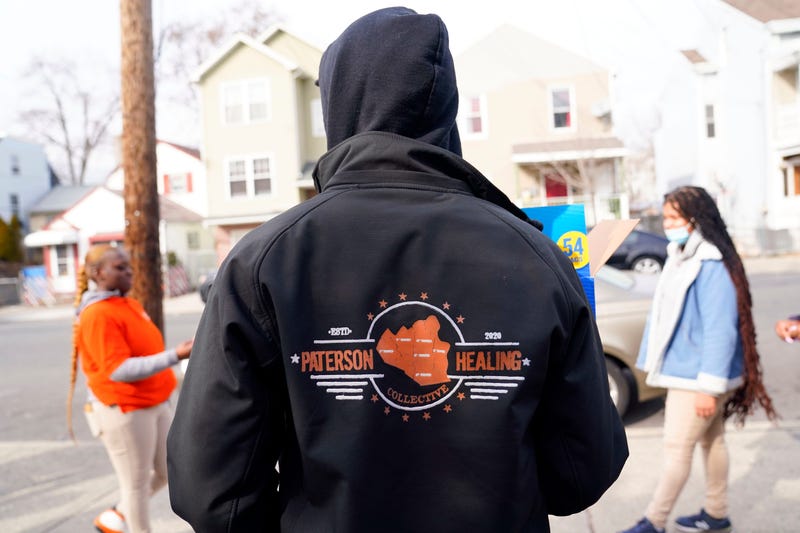 A Paterson Healing Collective worker handing out snacks after a fatal stabbing at a local school. Police fatally shot a member of the violence interruption group who was suffering a mental health crisis on Friday.