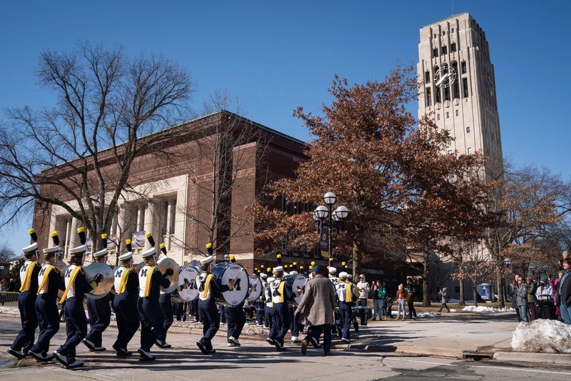 University of Michigan's marching band leads a procession through campus to Hill Auditorium, March 7, 2023