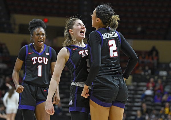 TCU Horned Frogs guard Emily Fisher (5) and TCU Horned Frogs guard Tara Manumaleuga (2) reacts after a basket during the second half at Municipal Auditorium