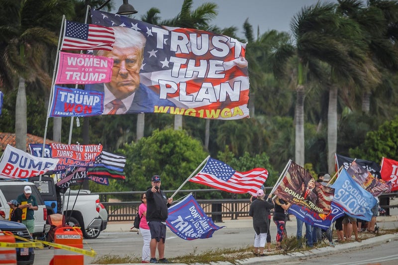 Supporters of the former President Donald Trump congregate just west of Mar-a-Lago on Southern Boulevard in Palm Beach, Fla., on March 19, 2023. Trump called for supporters to protest after claiming that he will be arrested on Tuesday following the Manhattan district attorney's investigation into hush money paid to Stormy Daniels in 2016. 