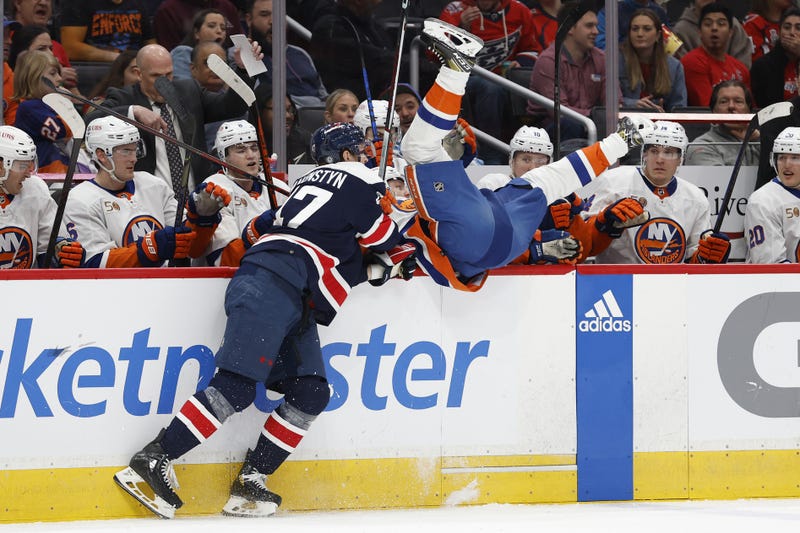 New York Islander hit into bench by a Washington Capital