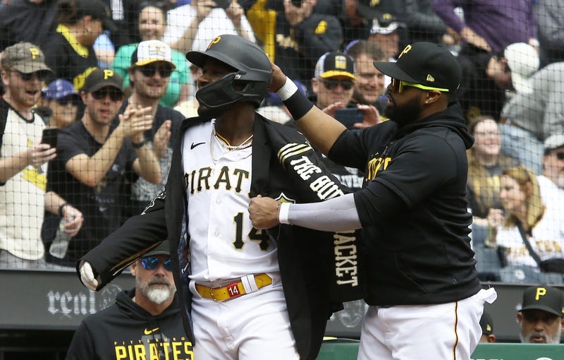 Pittsburgh Pirates infielder Carlos Santana (right) puts the Pirates Home Run jacket on shortstop Rodolfo Castro (14) after Castro hit a solo home run against the Los Angeles Dodgers