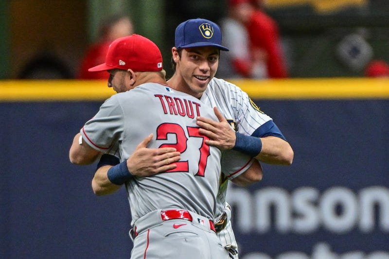 Apr 29, 2023; Milwaukee, Wisconsin, USA; Milwaukee Brewers left fielder Christian Yelich (22) greets Los Angeles Angels center fielder Mike Trout (27) before a game at American Family Field. Mandatory Credit: Benny Sieu-Imagn Images