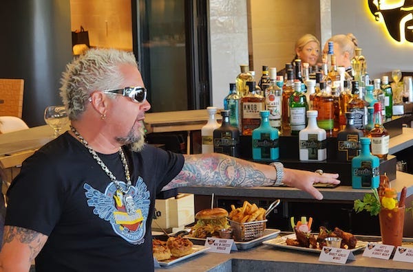 Guy Fieri describes some of the dishes on his menu at Guy Fieri's Kitchen + Bar in Council Bluffs