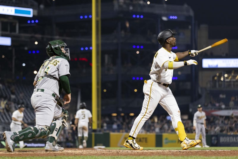 Pittsburgh Pirates designated hitter Andrew McCutchen (22) and Oakland Athletics catcher Shea Langeliers (23) watch the ball on a sacrifice fly that scores the winning run