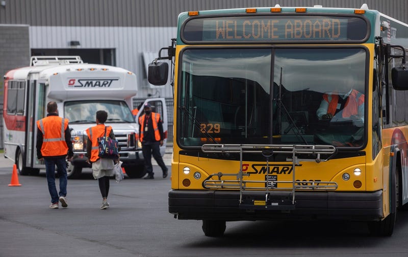 A crash between a pickup truck and a SMART bus sent three people to the hospital on Friday morning after the truck driver barreled through a red light, police said.