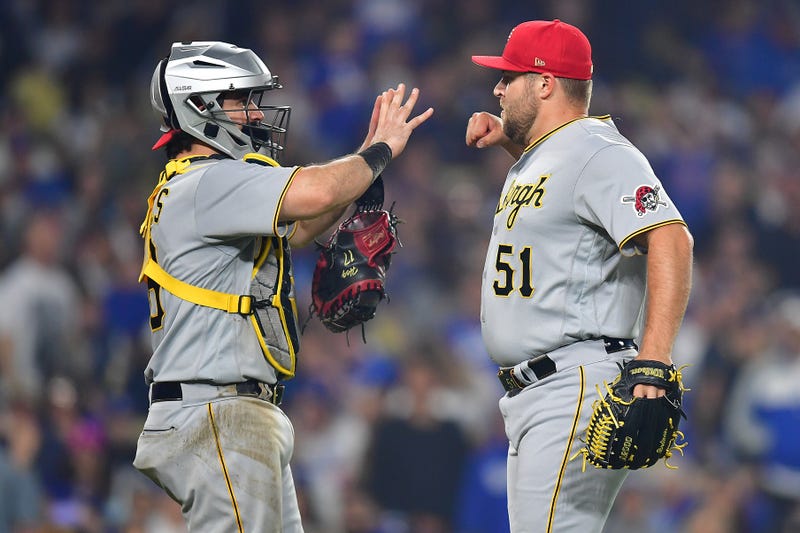 Pittsburgh Pirates relief pitcher David Bednar (51) and catcher Austin Hedges (18) celebrate the victory