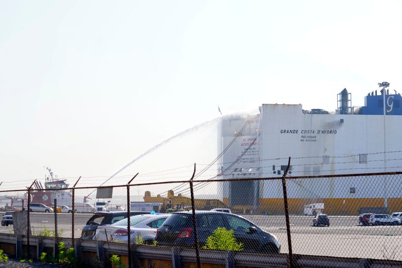 Firefighters at the scene of a cargo ship fire in Newark on July 6, 2023
