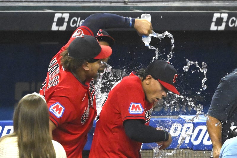 Jul 25, 2023; Cleveland, Ohio, USA; Cleveland Guardians first baseman Josh Naylor (22) pours water on his brother catcher Bo Naylor (23) after a win over the Kansas City Royals at Progressive Field. 