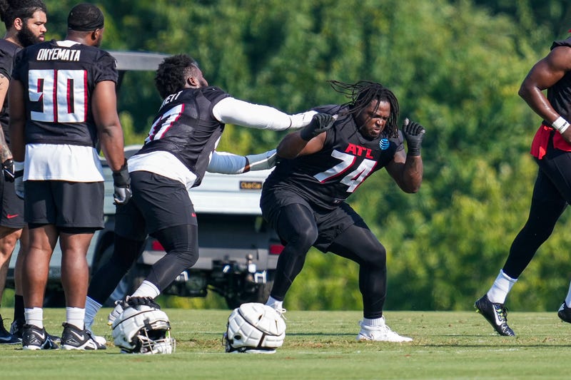 Atlanta Falcons defensive lineman Carlos Davis (74) and defensive end Grady Jarrett (97) battle during training camp.