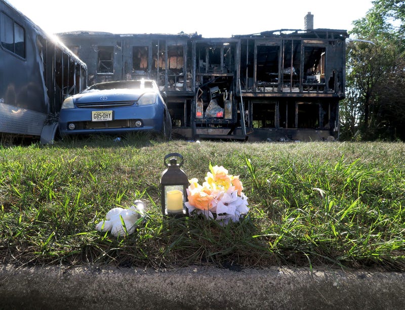 A memorial sits on the curb outside 507 Buttonwood Drive in Lacey Township