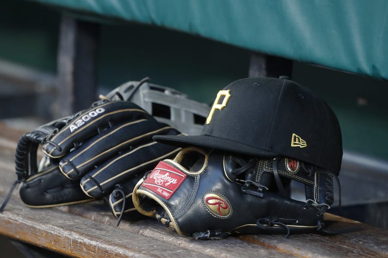 Pittsburgh Pirates hat and gloves in the dugout against the Atlanta Braves during the fourth inning at PNC Park. 