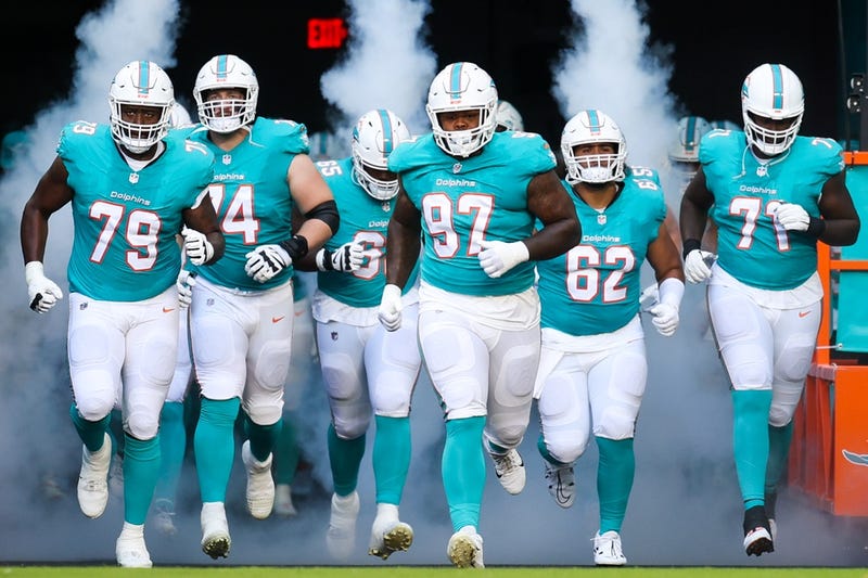 Miami Dolphins offensive tackle Cedric Ogbuehi (79) defensive tackle Jaylen Twyman (97) and offensive tackle Kion Smith (71) take the field for a game against the Atlanta Falcons at Hard Rock Stadium.