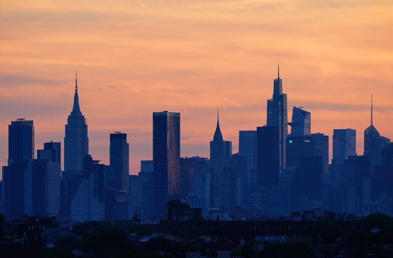 The sun sets over the New York City skyline, as seen from Arthur Ashe Stadium in Queens