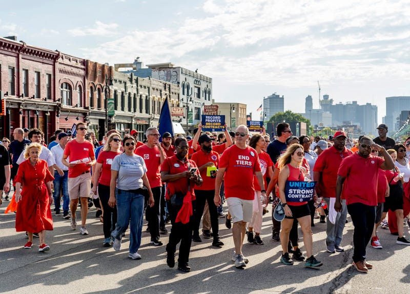 UAW President Shawn Fain, center, walks with officials and union members during the Labor Day parade along Michigan Avenue in Detroit's Corktown neighborhood on Monday, September 4, 2023, to Roosevelt Park in front of the Michigan Central Station.