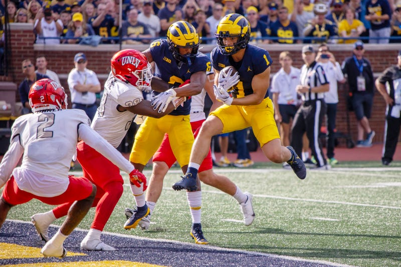 Michigan Wolverines wide receiver Roman Wilson (1) catches the ball and runs in in for a touchdown against the UNLV Rebels during the first half at Michigan Stadium.
