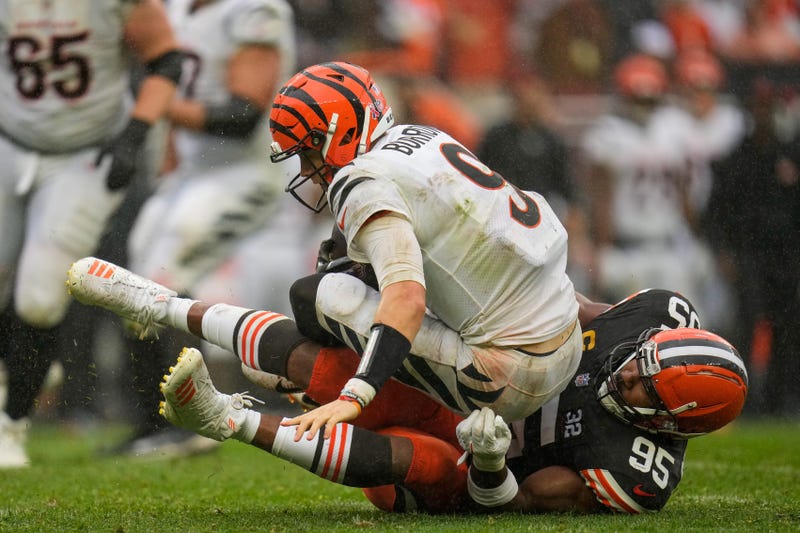 Cincinnati Bengals quarterback Joe Burrow (9) is sacked by Cleveland Browns defensive end Myles Garrett (95) to turnover on downs in the fourth quarter of the NFL Week 1 game between the Cleveland Browns and the Cincinnati Bengals at FirstEnergy Stadium in downtown Cleveland on Sunday, Sept. 10, 2023. The Browns dealt the Bengals a 24-3 loss to begin the season.