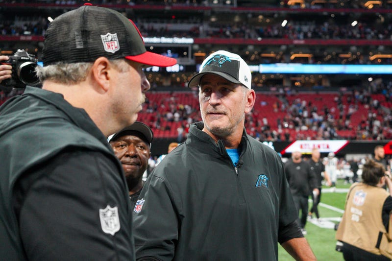 Atlanta Falcons HC Arthur Smith talks to Carolina Panthers HC Frank Reich after a game at Mercedes-Benz Stadium.