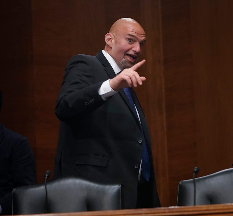 Senator John Fetterman, D-Pa., returns to Capitol Hill during a hearing of the Senate Banking, Housing, and Urban Affairs considering nominations on Tuesday, April 18, 2023.